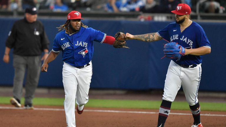 Toronto Blue Jays first baseman Vladimir Guerrero Jr., left, is congratulated by Alek Manoah after making an out against the Tampa Bay Rays to end the top of the fifth inning of a baseball game. (Adrian Kraus/AP)