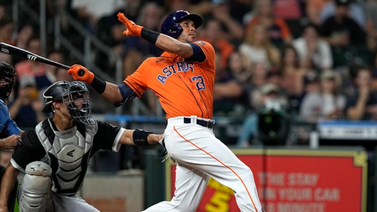 Houston Astros' Michael Brantley (23) hits a grand slam as Chicago White Sox catcher Seby Zavala reaches for the pitch during the sixth inning of a baseball game Friday, June 17, 2022, in Houston. (David J. Phillip/AP)