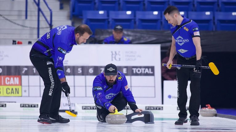 Reid Carruthers (centre) shoots a stone during Draw 11 of the WFG Masters on Dec. 8, 2022, at Sixteen Mile Sports Complex in Oakville, Ont. (Anil Mungal/GSOC)