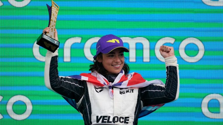 Jamie Chadwick, of Britain, holds the trophy after winning the W Series auto race at the Circuit of the Americas, Sunday, Oct. 24, 2021, in Austin, Texas. (Darron Cummings/AP)