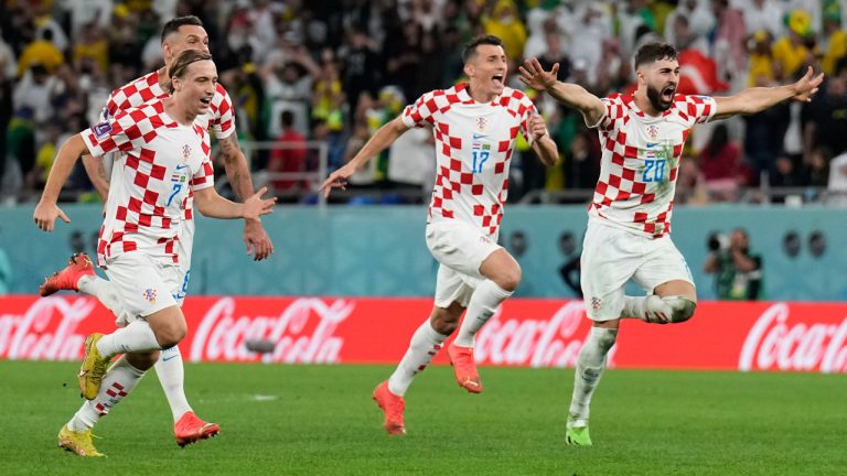 Croatia's Lovro Majer, from left, Croatia's Ante Budimir and Croatia's Josko Gvardiol celebrate after the penalty shootout at the World Cup quarterfinal soccer match between Croatia and Brazil, at the Education City Stadium in Al Rayyan, Qatar, Friday, Dec. 9, 2022. (Martin Meissner/AP) 