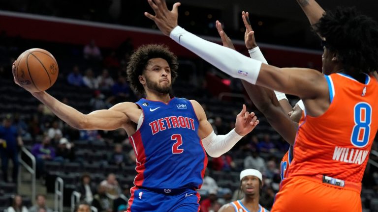 Detroit Pistons guard Cade Cunningham (2) passes around the defense of Oklahoma City Thunder forward Jalen Williams (8) during the second half of an NBA basketball game, Monday, Nov. 7, 2022, in Detroit. (Carlos Osorio/AP)