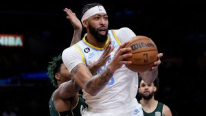 Los Angeles Lakers' Anthony Davis (3) looks to pass under pressure by Boston Celtics' Marcus Smart during first half of an NBA basketball game Tuesday, Dec. 13, 2022, in Los Angeles. (Jae C. Hong/AP)