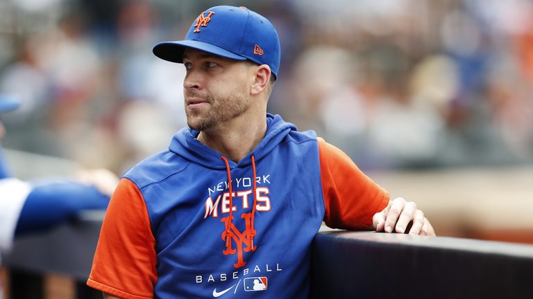 Former New York Mets pitcher Jacob deGrom looks on in the dugout during the seventh inning of a baseball game against the Washington Nationals, Sunday, Sept. 4, 2022, in New York. (Noah K. Murray/AP)