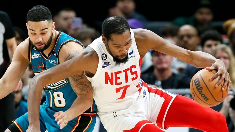 Brooklyn Nets forward Kevin Durant (7) maintains control of the ball collides with Detroit Pistons guard Cory Joseph (18) after stealing the ball during the second half of an NBA basketball game, Sunday, Dec. 18, 2022, in Detroit. The Nets defeated the Pistons 124-121. (AP Photo/Duane Burleson)