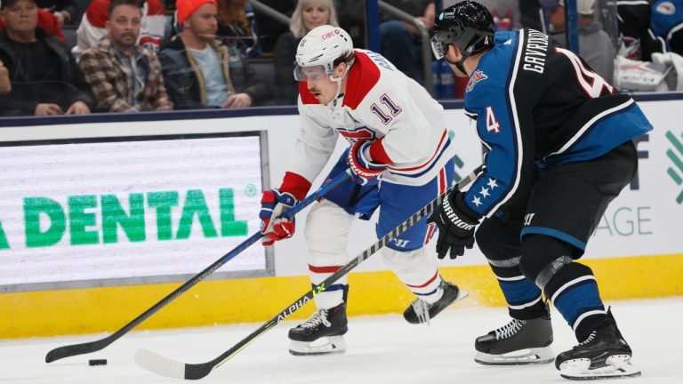 Montreal Canadiens' Brendan Gallagher, left, carries the puck up ice past Columbus Blue Jackets' Vladislav Gavrikov during the third period of an NHL hockey game on Wednesday, Nov. 23, 2022, in Columbus, Ohio. (Jay LaPrete/AP)