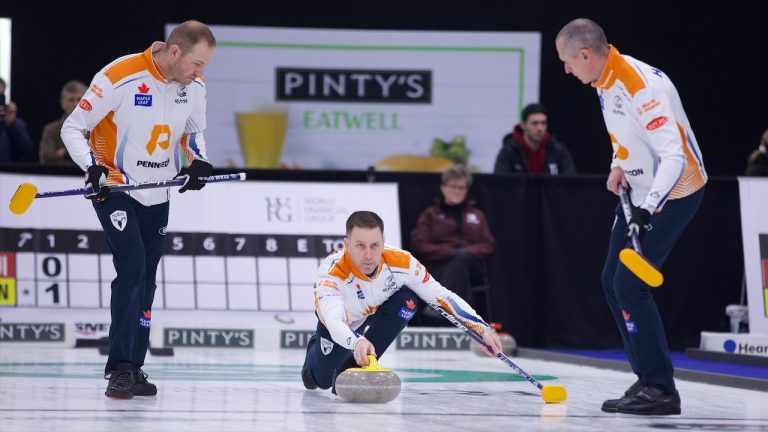 Brad Gushue (centre) delivers a rock during the second draw of the WFG Masters on Dec. 6, 2022, at Sixteen Mile Sports Complex in Oakville, Ont. (Anil Mungal/GSOC)