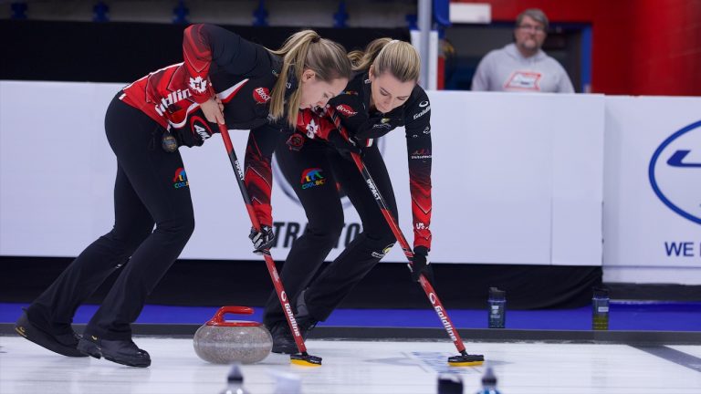 Rachel Homan (left) and Emma Miskew (right) sweep a stone during Draw 3 of the WFG Masters on Dec. 6, 2022, at Sixteen Mile Sports Complex in Oakville, Ont. (Anil Mungal/GSOC)