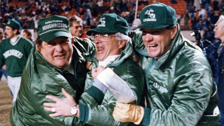 Saskatchewan Roughriders coaches )left to right) Ted Heath, John Gregory and Ron Cherkus celebrate as they march across the field after defeating the Edmonton Eskimos for the Western Final. (Dave Buston/CP)