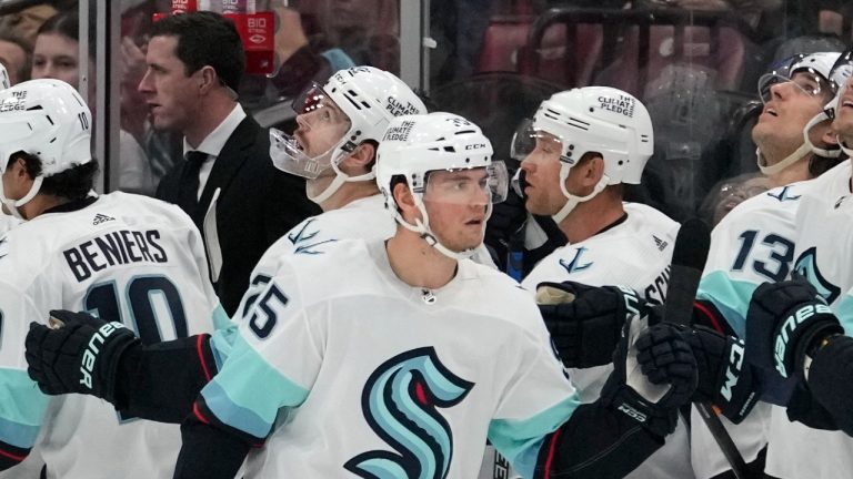 Seattle Kraken left wing Andre Burakovsky, left, is congratulated after scoring a goal during the second period of an NHL hockey game against the Florida Panthers, Sunday, Dec. 11, 2022, in Sunrise, Fla. (AP Photo/Lynne Sladky)