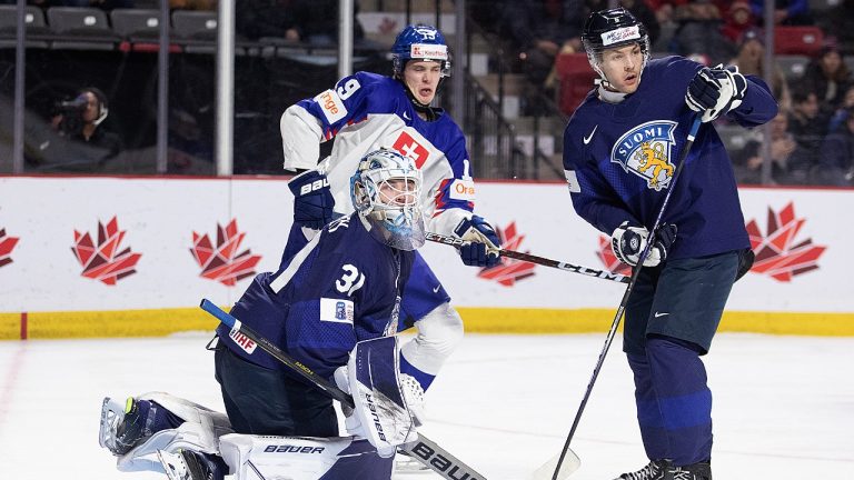 Finlands goaltender Jani Lampinen, Slovakia's Adam Zlnka and Finland's Kalle Ervasti watch for a shot during first period IIHF World Junior Hockey Championship hockey action in Moncton, N.B., on Tuesday, Dec. 27, 2022. (Ron Ward/CP)