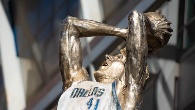 Dirk Nowitzki's statue is unveiled during the "All Four One" statue ceremony in front of the American Airlines Center in Dallas, Sunday, Dec. 25, 2022. (Emil T. Lippe/AP Photo)