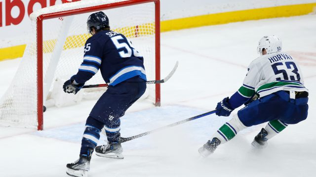 Mark Scheifele's hat trick carries Jets past Canucks