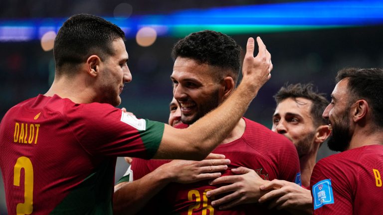 Portugal's Goncalo Ramos, center, celebrates with teammates after scoring his his side's third goal during the World Cup round of 16 soccer match between Portugal and Switzerland, at the Lusail Stadium. (Manu Fernandez/AP)