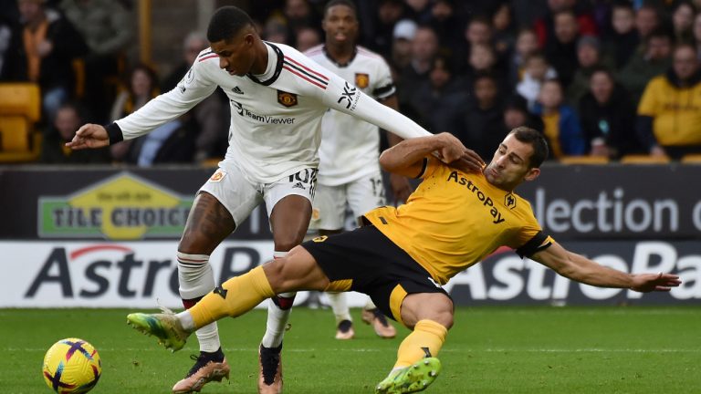 Manchester United's Marcus Rashford, left, duels for the ball with Wolverhampton Wanderers' Jonny during the English Premier League soccer match between Wolverhampton Wanderers and Manchester United at the Molineux Stadium in Wolverhampton, England, Saturday, Dec. 31, 2022. (Rui Vieira/AP) 