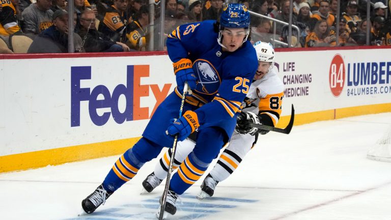 Buffalo Sabres' Owen Power (25) controls the puck in front of Pittsburgh Penguins' Sidney Crosby (87) during the second period of an NHL hockey game. (Gene J. Puskar/AP)