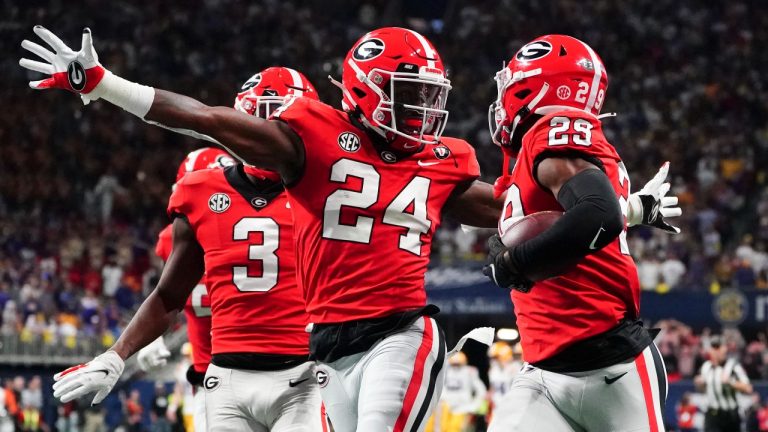 Georgia defensive back Malaki Starks (24) reacts as Georgia defensive back Christopher Smith (29) returns a blocked LSU field goal attempt for a touchdown in the first half of the Southeastern Conference Championship football game Saturday, Dec. 3, 2022 in Atlanta. (John Bazemore/AP)