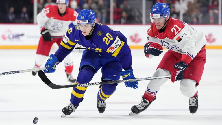 Sweden’s Liam Ohgren, left, protects the puck from Czechia’s Jaroslav Chmelar during second period IIHF World Junior Hockey Championship action in Halifax, Thursday, Dec. 29, 2022. (Darren Calabrese/CP) 