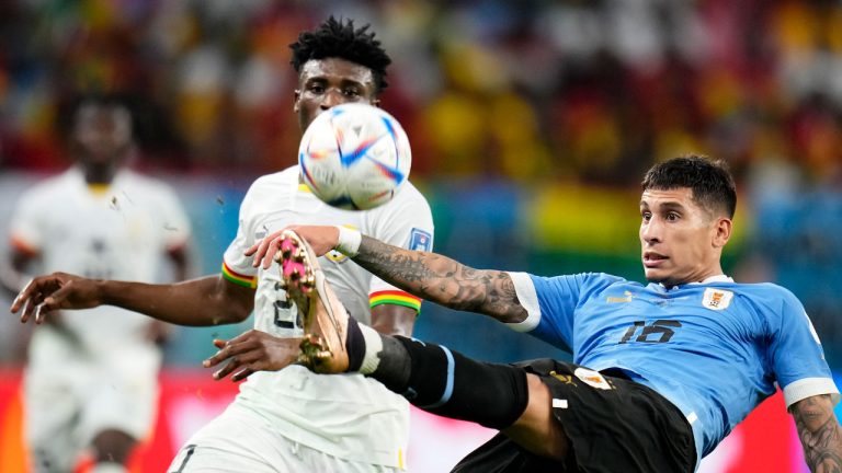 Uruguay's Mathias Olivera, right, and Ghana's Mohammed Kudus challenge for the ball during the World Cup group H soccer match between Ghana and Uruguay, at the Al Janoub Stadium. (Manu Fernandez/AP)