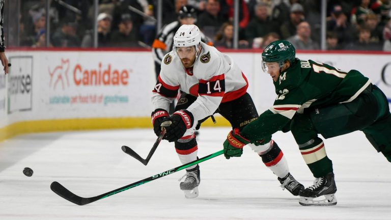 Ottawa Senators center Tyler Motte (14) battles for the puck with Minnesota Wild left wing Matt Boldy (12) during the second period of an NHL hockey game, Sunday, Dec. 18, 2022, in St. Paul, Minn. (Craig Lassig/AP) 