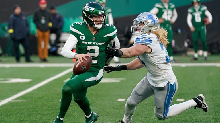 New York Jets quarterback Zach Wilson (2) scrambles under pressure from Detroit Lions linebacker Alex Anzalone (34) during the fourth quarter of an NFL football game, Sunday, Dec. 18, 2022, in East Rutherford, N.J. (Seth Wenig/AP)