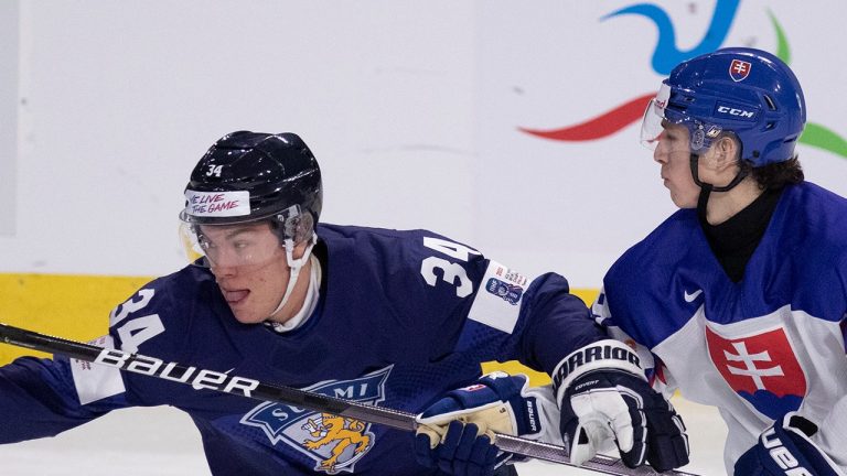 Finland's Kaskimäki  Aleksanteri skates pass Slovakia's Adam Zlnka during second period IIHF World Junior Hockey Championship hockey action in Moncton, N.B., on Tuesday, Dec. 27, 2022. (Ron Ward/THE CANADIAN PRESS)