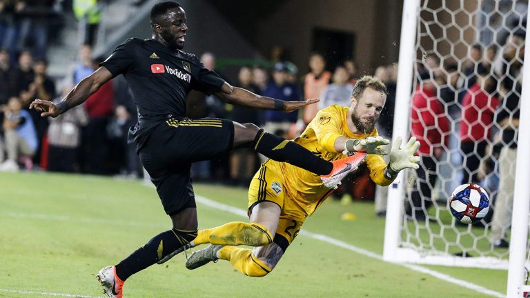 Seattle Sounders goalkeeper Stefan Frei, right, makes a save against Los Angeles FC forward Adama Diomande during the second half of the MLS soccer Western Conference final Tuesday, Oct. 29, 2019, in Los Angeles. (Ringo H.W. Chiu/AP)