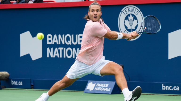 Alexis Galarneau of Canada returns to Grigor Dimitrov of Belarus during first round of play at the National Bank Open tennis tournament Tuesday August 9, 2022 in Montreal. (Paul Chiasson/CP)