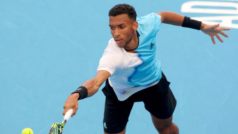 Canada's Felix Auger-Aliassime makes a backhand return to Australia's Alexei Popryin during their Round of 32 match at the Adelaide International Tennis tournament in Adelaide, Australia, Monday, Jan. 2, 2023. (Kelly Barnes/AP Photo)