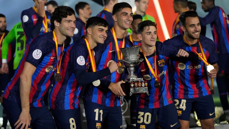 Barcelona players celebrate with a trophy after the won the final of the Spanish Super Cup between Barcelona and Real Madrid in Riyadh, Saudi Arabia, Sunday, Jan. 16, 2023. (Hussein Malla/AP)