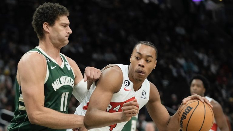 Toronto Raptors' Scottie Barnes tries to get past Milwaukee Bucks' Brook Lopez during the first half of an NBA basketball game Tuesday, Jan. 17, 2023, in Milwaukee. (Morry Gash/AP Photo)