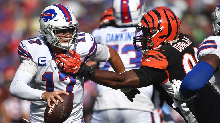 Cincinnati Bengals defensive end Carlos Dunlap (96) reaches for Buffalo Bills quarterback Josh Allen (17) during the second half of an NFL football game Sunday, Sept. 22, 2019, in Orchard Park, N.Y. (Adrian Kraus/AP)