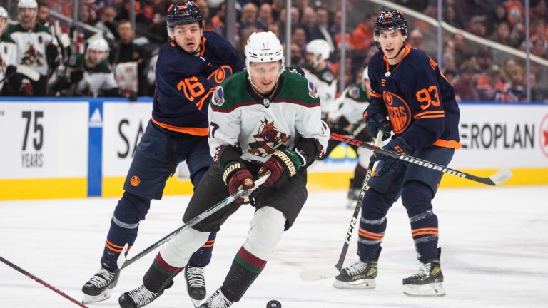 Arizona Coyotes' Nick Bjugstad (17) is chased by Edmonton Oilers' Mattias Janmark (26) and Ryan Nugent-Hopkins (93) during first period NHL action in Edmonton on Wednesday, December 7, 2022. (Jason Franson/CP)