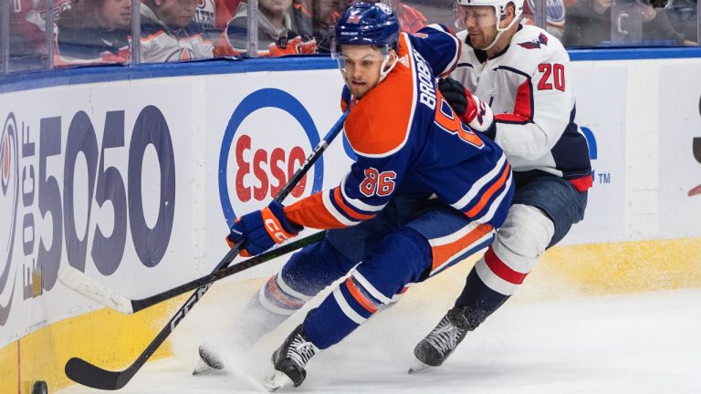 Washington Capitals' Lars Eller (20) and Edmonton Oilers' Philip Broberg (86) battle for the puck during first period NHL action in Edmonton, Monday, Dec. 5, 2022. (Jason Franson/CP)