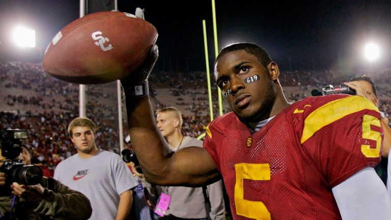 FILE - Southern California tail back Reggie Bush walks off the field holding the game ball after the Trojans defeated Fresno State, 50-42, at the Los Angeles Coliseum on Nov. 19, 2005. Reggie Bush, whose Heisman Trophy victory for Southern California in 2005 was vacated because of NCAA violations, was among 18 players in the latest College Football Hall of Fame class announced Monday, Jan. 9, 2023. (Kevork Djansezian/AP, File)