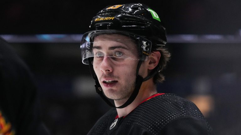 Vancouver Canucks' Quinn Hughes lines up for a faceoff against the Seattle Kraken during the second period of an NHL hockey game. (Darryl Dyck/CP)