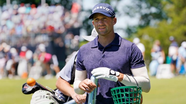 Ben Silverman, of Canada, walks with a basket of golf balls on the range during a practice round ahead of the U.S. Open golf tournament, Tuesday, June 14, 2022, at The Country Club in Brookline, Mass. (AP)