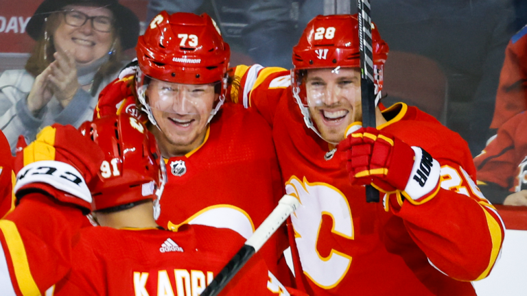 Calgary Flames forward Elias Lindholm, right, celebrates his goal with teammate forward Tyler Toffoli during second period NHL hockey action against the Los Angeles Kings in Calgary, Monday, Nov. 14, 2022. (CP)