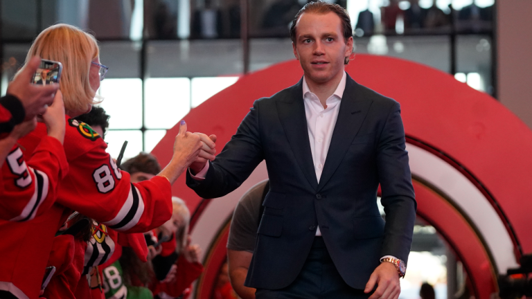 Chicago Blackhawks right wing Patrick Kane walks the red carpet on opening night before an NHL hockey game against the Detroit Red Wings, Friday, Oct. 21, 2022, in Chicago. (AP)