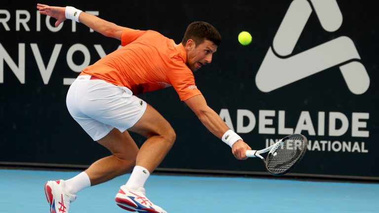 Serbia's Novak Djokovic makes a backhand return to France's Constant Lestienne during their Round of 32 match at the Adelaide International Tennis tournament in Adelaide, Australia, Tuesday, Jan. 3, 2023. (AP Photo/Kelly Barnes)