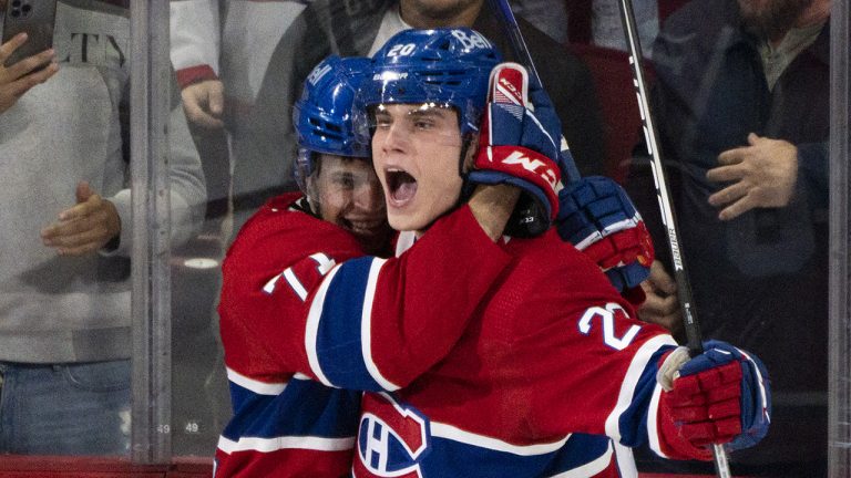 Montreal Canadiens' Juraj Slafkovsky celebrates his goal against the Arizona Coyotes with teammate Jake Evans during second period NHL hockey action in Montreal, on Thursday, October 20, 2022. (Paul Chiasson/CP)