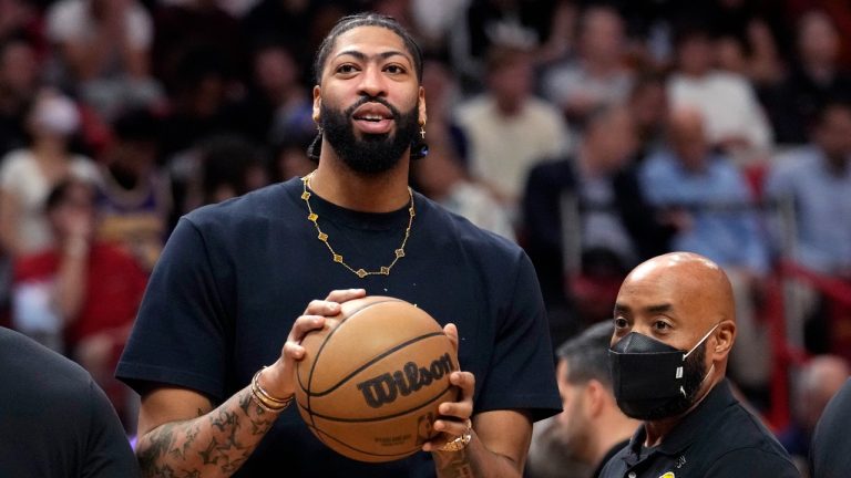 Los Angeles Lakers forward Anthony Davis watches from the bench during the first half of an NBA basketball game against the Miami Heat, Wednesday, Dec. 28, 2022, in Miami. (Lynne Sladky/AP Photo)