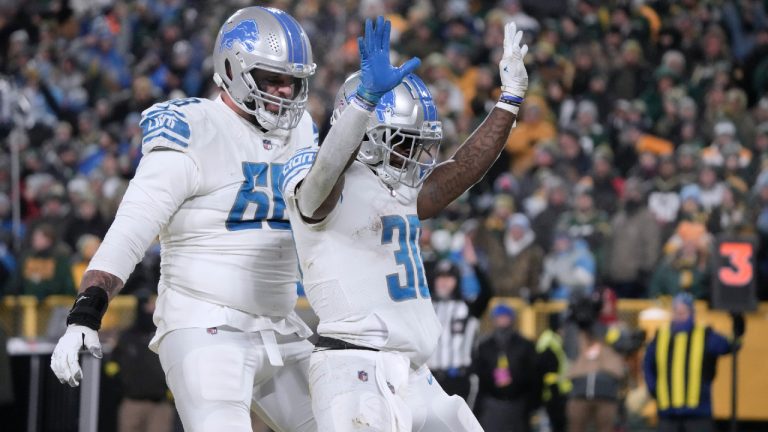 Detroit Lions running back Jamaal Williams (30) celebrates after scoring as teammate Taylor Decker (68) watches during the second half of an NFL football game Sunday, Jan. 8, 2023, in Green Bay, Wis. (Morry Gash/AP)