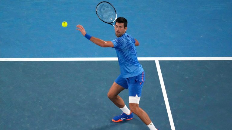 Novak Djokovic of Serbia plays a forehand return to Roberto Carballes Baena of Spain during their first round match at the Australian Open tennis championship. (Aaron Favila/AP)