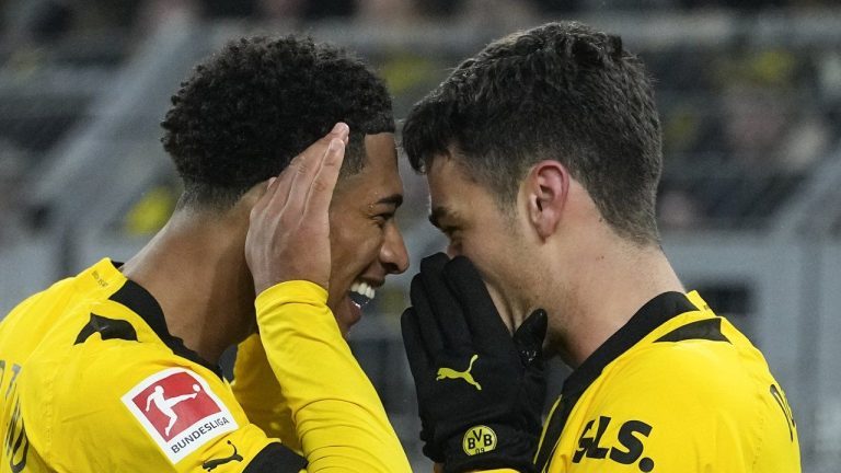 Dortmund's Jude Bellingham, left, celebrates with Dortmund's Giovanni Reyna, right, who scored his side's fourth goal during the German Bundesliga soccer match between Borussia Dortmund and FC Augsburg in Dortmund, Germany, Sunday, Jan. 22, 2023. (Martin Meissner/AP)