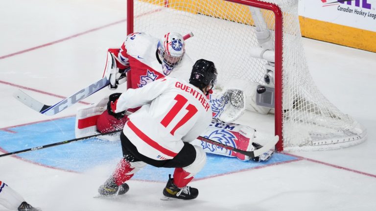 Canada's Dylan Guenther, right, scores the game winning goal past Czechia goaltender Tomas Suchanekin during overtime of the IIHF World Junior Hockey Championship gold medal game in Halifax on Thursday, January 5, 2023. (Darren Calabrese/CP)