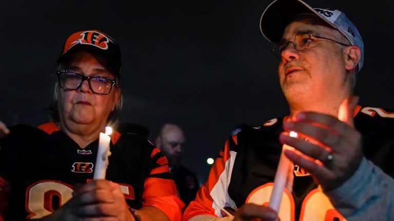 Fans light candles as they gather outside University of Cincinnati Medical Center, late Monday, Jan. 2, 2023, in Cincinnati, where Buffalo Bills' Damar Hamlin was taken after collapsing on the field during an NFL football game against the Cincinnati Bengals. (Jeff Dean/AP Photo)