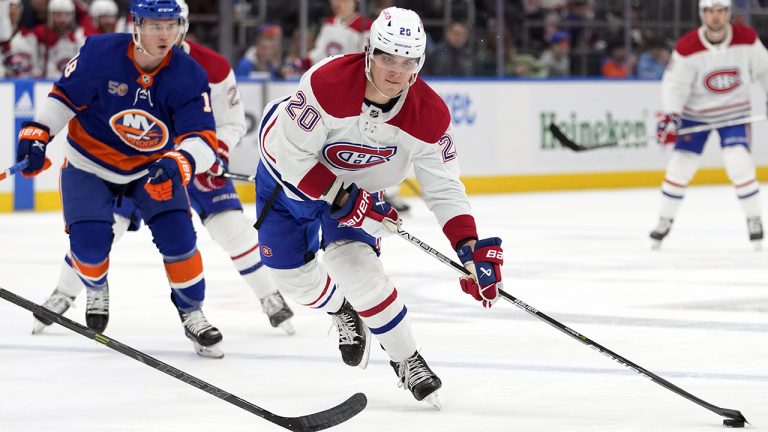 Montreal Canadiens left wing Juraj Slafkovsky (20) skates ahead of New York Islanders left wing Anthony Beauvillier during the first period of an NHL hockey game, Saturday, Jan. 14, 2023, in Elmont, N.Y. (Mary Altaffer/AP)