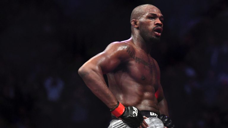 Jon Jones goes up on top of the octagon. (Kyusung Gong/AP)