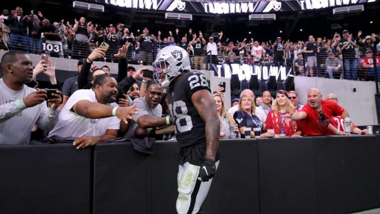 Las Vegas Raiders running back Josh Jacobs reacts with fans after a touchdown during the second half of an NFL football game against the Houston Texans Sunday, Oct. 23, 2022, in Las Vegas. (David Becker/AP)